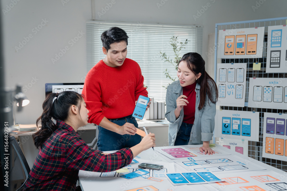 Poster diverse team of designers actively collaborates on a mobile app project, discussing user interface l