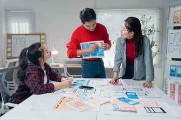 Design team engaged in a creative brainstorming session, discussing and developing user interface...