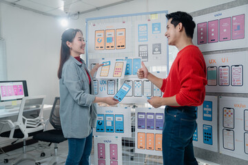 Two designers engaging in a creative discussion about mobile app UX/UI design. They analyze...