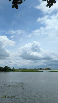 Traditional Boat Navigating Waterway Under Cloudy Sky | Rural Bangladesh Monsoon Travel
