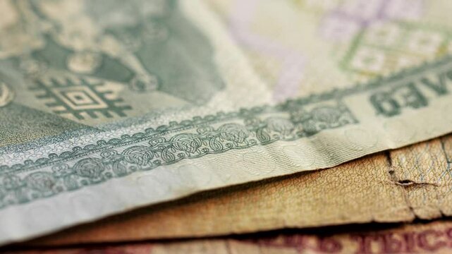 Static macro shot of different Belarusian ruble banknotes dropping into frame