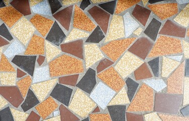 A vibrant arrangement of broken tiles in multiple shades creates an eye-catching mosaic pattern on the surface