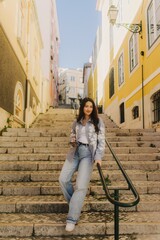 Vlogger traveler girl recording video on phone share via app her travel vacation in the Lisbon. Woman influencer shooting social media stories on the street leading. UGC. Part of a series