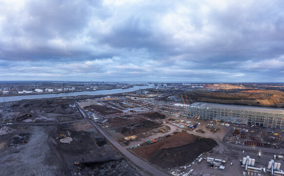 Aerial view of the industrial landscape where the River Tees flows into the North Sea, under a sky heavy with cloud, Middlesbrough, England, United Kingdom.