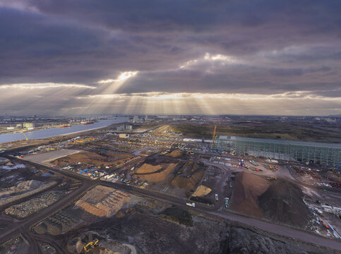 Aerial view of sun rays piercing through dramatic clouds over the industrial landscape and the Port of Middlesbrough, Middlesbrough, England, United Kingdom.