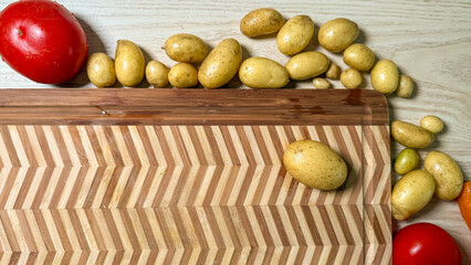 Golden nuggets cascade beside vibrant tomatoes on zigzagged wood, invoking Celtic harvest and...