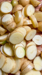 Golden potato slices glisten like rustic sunflowers, evoking ancient Latvian Jumis harvest, embodying earthy abundance and culinary transformation