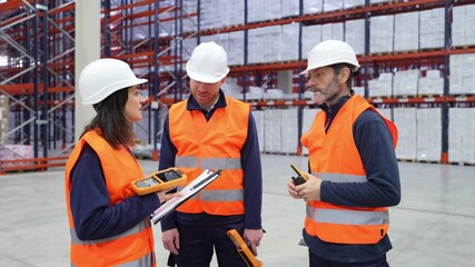Professional warehouse team collaborating, scanning barcodes and analyzing inventory data using digital handheld devices and clipboards in industrial storage facility - Powered by Adobe