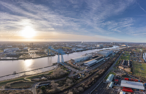 Aerial view of the iconic Middlesbrough Transporter Bridge spanning the river under a vast sky, Stockton-on-Tees, England, United Kingdom.