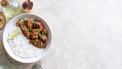 Chicken wings in teriyaki sauce with rice, sesame and onion. Asian food.