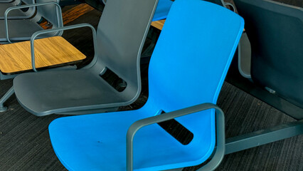 Blue chair beckons serenity, poised in airport lounge; travel anticipation, World Tourism Day, and...
