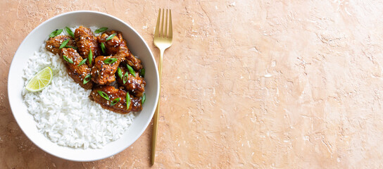 Chicken wings in teriyaki sauce with rice, sesame and onion. Asian food.