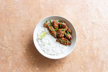 Chicken wings in teriyaki sauce with rice, sesame and onion. Asian food.