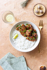 Chicken wings in teriyaki sauce with rice, sesame and onion. Asian food.