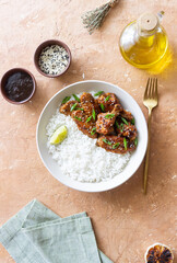 Chicken wings in teriyaki sauce with rice, sesame and onion. Asian food.