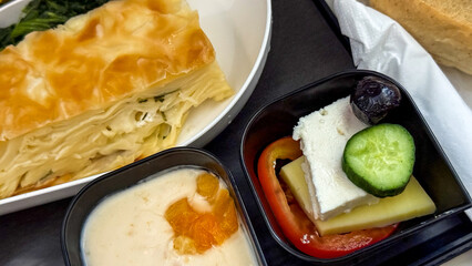 Golden-crusted borek nestles beside tangy feta with cucumber, evoking Balkan culinary celebrations...