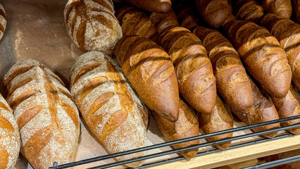 Golden, crusty loaves bask in warm bakery glow, evoking Lammas harvest celebrations and the coziness of Hygge rituals