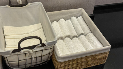 Crisp folded towels in woven baskets evoke spa-like tranquility, perfect for Hygge rituals or...