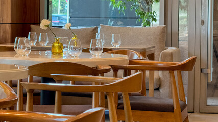 Elegant minimalist dining setting with wooden chairs, echoing Nordic simplicity, perfect for Hygge gatherings and Slow-Food Movement celebrations