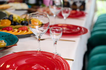 The table is beautifully arranged with vibrant plates, glasses, and a variety of delicious foods for a special occasion.