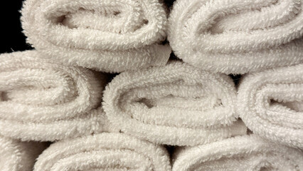 Neatly stacked plush white towels, echoing spa serenity, evoke World Pampering Day's therapeutic...