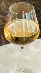 A golden nectar swirls elegantly in a crystal goblet, evoking midsummer's Eve and Bacchanalian indulgence