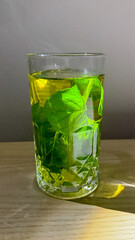 Emerald mint tea shimmering in golden sunlight, savor the zen vibes of Wellness Wednesday or Green Monday mindfulness
