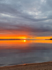 Serene sunset ignites the tranquil lake sky, evoking Solstice reflections and World Water Day's ethereal aquatic reverie
