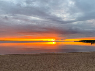 Majestic sunset over tranquil waters, celebrating Midsummer solstice and International Peace Day, ethereal hues whisper serene twilight symphony 