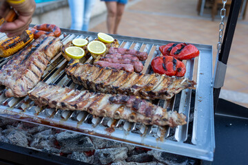 Delicious barbecue food grilling on a hot charcoal grill during a summer party