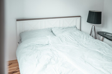 Bed with pillows in a bedroom. Minimalistic bedroom interior.