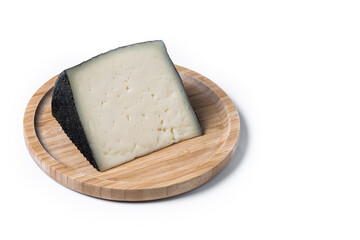 Close-up of a wedge of semi-cured cow's cheese isolated on white background. Copy space