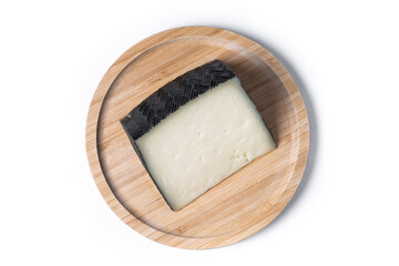 Close-up of a wedge of semi-cured cow's cheese isolated on white background