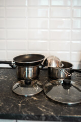 Pots and other kitchenware on a kitchentop. Clean kitchen concept.