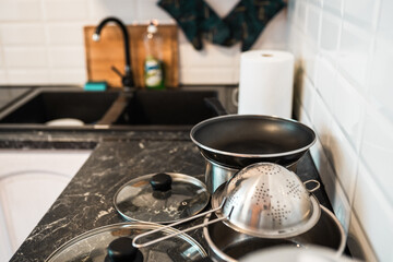 Pots and other kitchenware on a kitchentop. Clean kitchen concept.