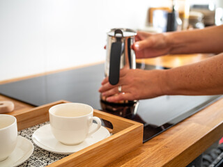 Making coffee in coffee pot in kitchen, close-up
