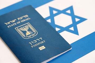 Israel passport on flag. The current Israel biometrical pass lies on flag close up