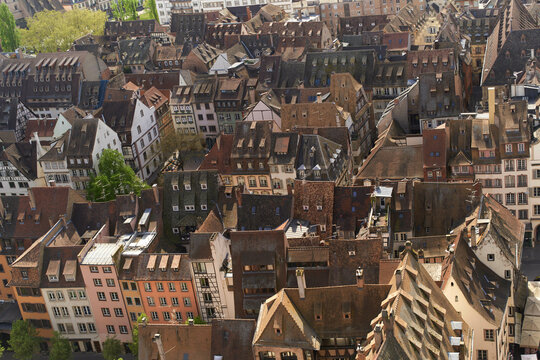 Aerial view of densely packed European rooftops with a mix of traditional architecture. Strasbourg, Grand Est region, France