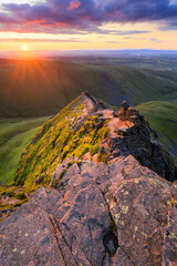 Golden summer sunrise from Blencathra overlooking Sharp Edge in The Lake District, UK.
