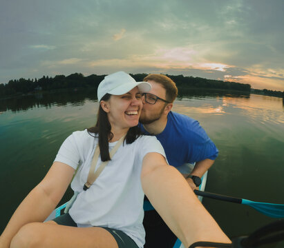 Couple Paddleboarding at Sunset