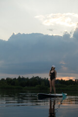Paddleboarding at Sunset on a Tranquil Lake