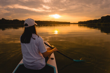 Paddleboarding at Sunset on a Calm Lake