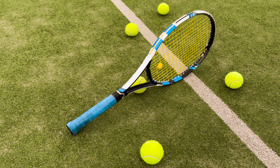 Tennis racket and ball on green background. Flat lay. Sports equipment