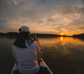 Paddleboarding at Sunset on a Calm Lake