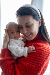 Tender Moment Between Mother and Baby by the Window