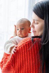 Tender Moment Between Mother and Baby by the Window