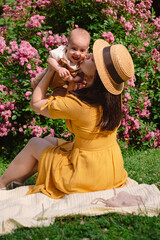 Joyful Mother and Baby in Blooming Garden