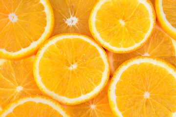 Close-up of fresh orange slices orange background