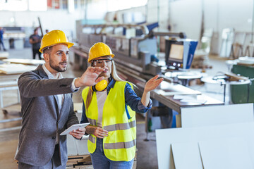 Business Professionals Collaborating in a Modern Industrial Machinery Environment