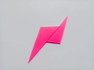 Pink lightning origami isolated on white background.